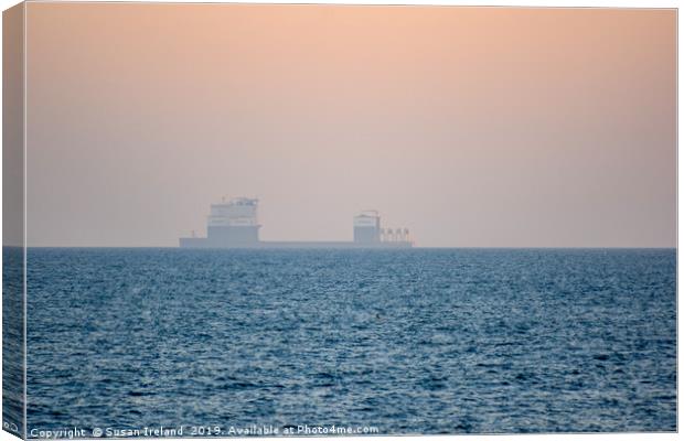 Boskalis ship in the horizon of a sunset Canvas Print by Susan Ireland