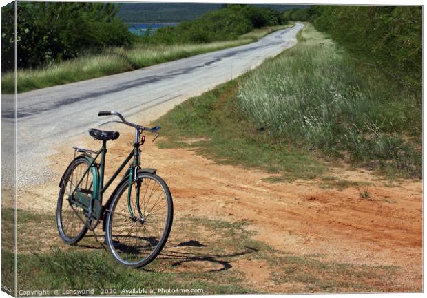 Retro bike next to an empty road in Cuba Canvas Print by Lensw0rld 
