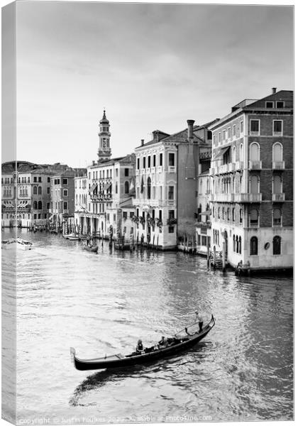 Gondolier on the Grand Canal, Venice, Italy Canvas Print by Justin Foulkes
