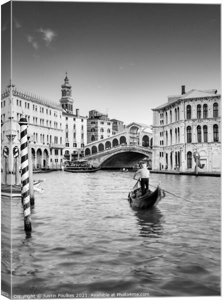Gondolier at the Rialto bridge, Grand Canal, Venic Canvas Print by Justin Foulkes