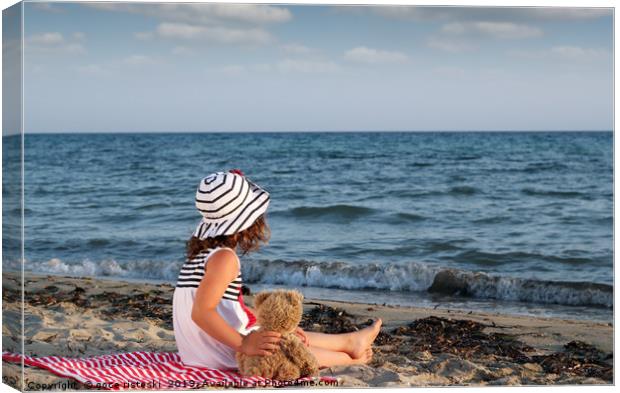 little girl with teddy bear sitting on beach Canvas Print by goce risteski