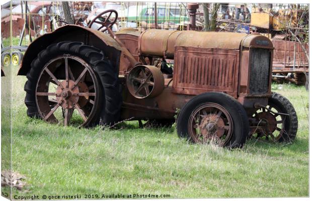 old rusty tractor on field Canvas Print by goce risteski