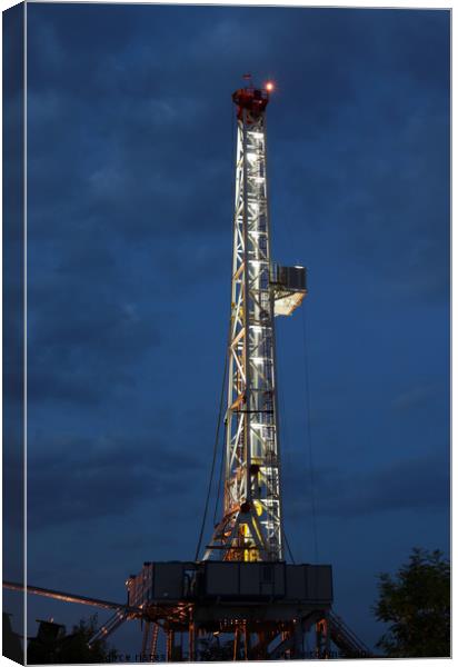 land oil drilling rig illuminated Canvas Print by goce risteski