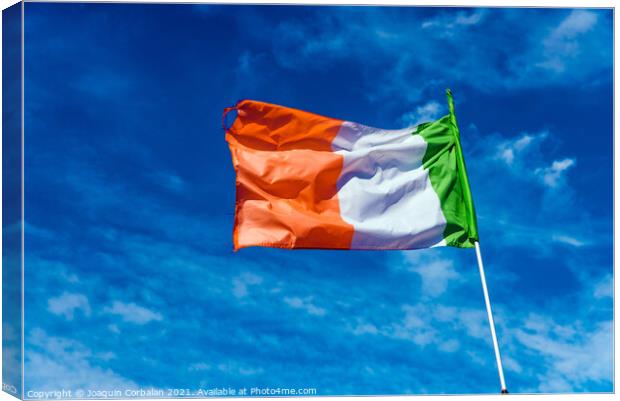 Flag of italy waving against the blue sky with clouds. Canvas Print by Joaquin Corbalan