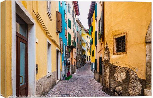 Old and narrow streets of beautiful typical Italian colors on a  Canvas Print by Joaquin Corbalan