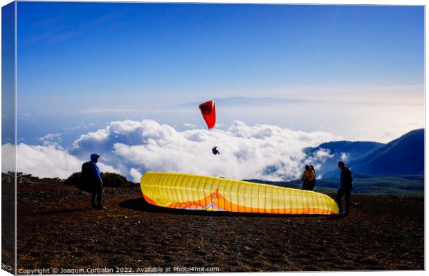 Skydiving experts and monitors prepare the sail of a paraglider  Canvas Print by Joaquin Corbalan