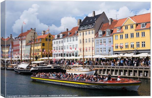 Copenhagen, Denmark - August 8, 2023: The most famous canal in Copenhagen with its quaint colorful houses overlooking the docked sailboats. Canvas Print by Joaquin Corbalan