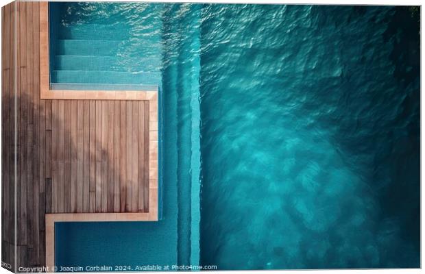 an aerial perspective of a swimming pool with a wooden deck. The pool is surrounded by the deck, providing ample space for relaxation and recreation. Canvas Print by Joaquin Corbalan