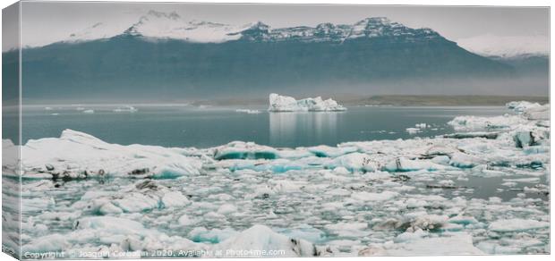 Huge blocks of ice on Glacial river and blue icebergs on Jokulsarlon glacier lake. Vatnajokull National Park, Iceland. Canvas Print by Joaquin Corbalan