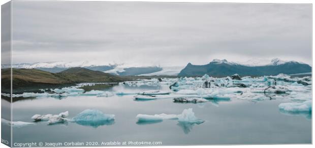 Huge blocks of ice on Glacial river and blue icebergs on Jokulsarlon glacier lake. Vatnajokull National Park, Iceland. Canvas Print by Joaquin Corbalan