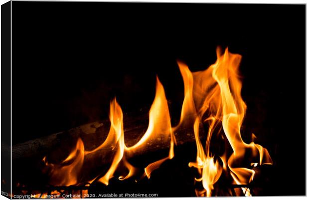 Flames in the fire of a red and yellow barbecue. Canvas Print by Joaquin Corbalan