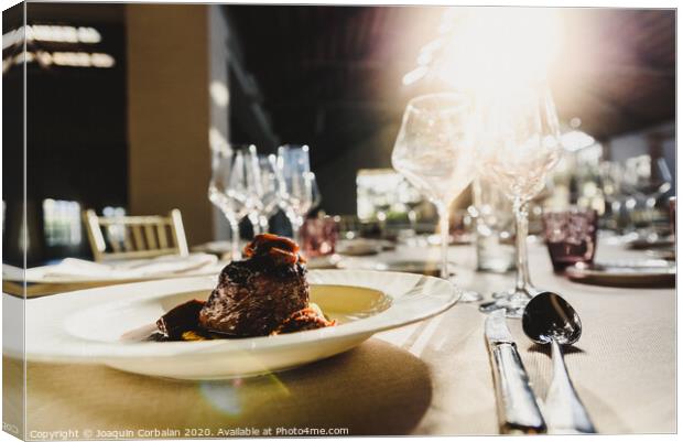Exquisite veal dish with sauce served in luxury cutlery with sunbeams in a restaurant. Canvas Print by Joaquin Corbalan