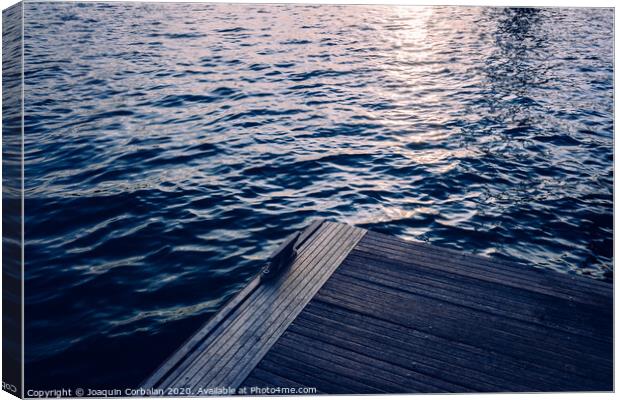 Sunset on a seawater jetty, with retro blue vintage tones, as a background for fashion. Canvas Print by Joaquin Corbalan