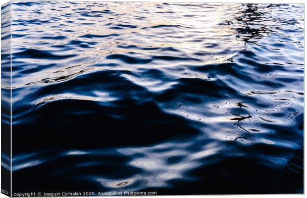 Natural seawater background with its intense bluish liquid texture at sunset. Canvas Print by Joaquin Corbalan