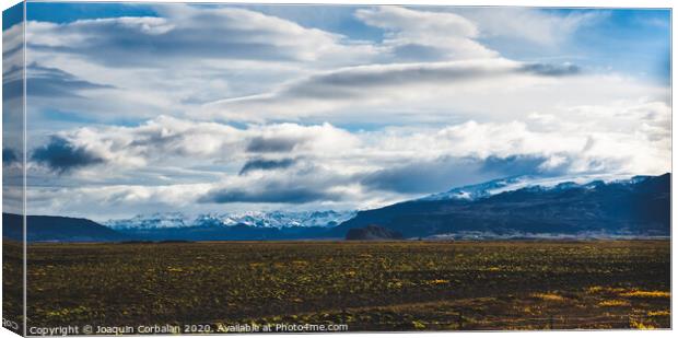 Beautiful and colorful blue skies with clouds and mountains in the background. Canvas Print by Joaquin Corbalan