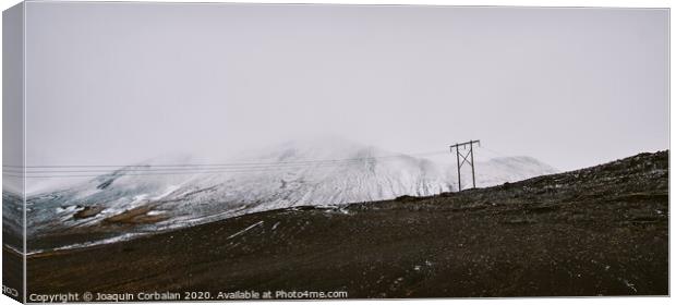 Poles of electricity in the middle of a snowy mountain to supply electrical power to remote villages. Canvas Print by Joaquin Corbalan