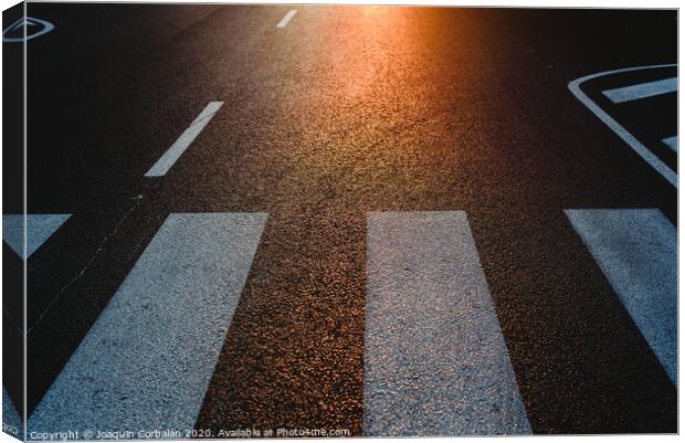 Lonely street with pedestrian crossing at sunset, texture with space for text. Canvas Print by Joaquin Corbalan