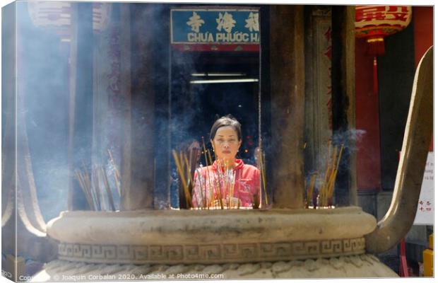 Ho Chi Ming, Vietnam - 27 October 2011: Asian religious people praying in Vietnam temple Canvas Print by Joaquin Corbalan