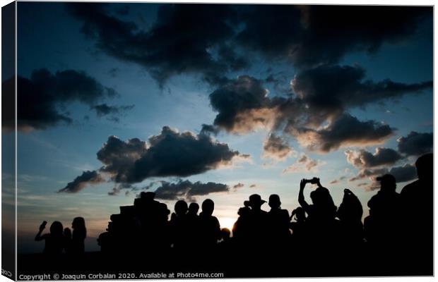 Group of people at sunrise photographing the sun, silhouettes of people Canvas Print by Joaquin Corbalan