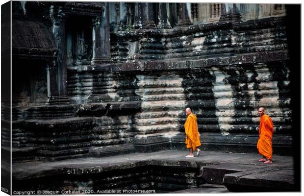 tibetan monks in orange robes visiting remote Cambodian temples to meditate. Canvas Print by Joaquin Corbalan