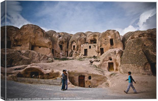 Caves excavated in the rock as dwellings in the city of Cavusin, in the region of Turkish Cappadocia. Canvas Print by Joaquin Corbalan