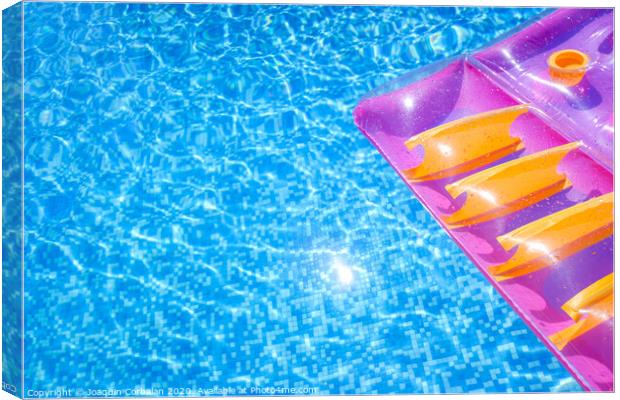 Transparent water from a pool, background with summer colored floats. Canvas Print by Joaquin Corbalan