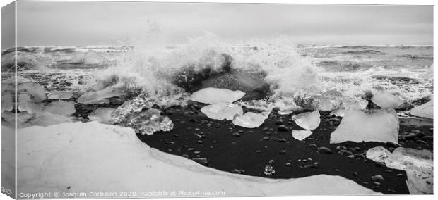 Giant ice blocks detached from icebergs on the coast of an Icelandic beach. Canvas Print by Joaquin Corbalan