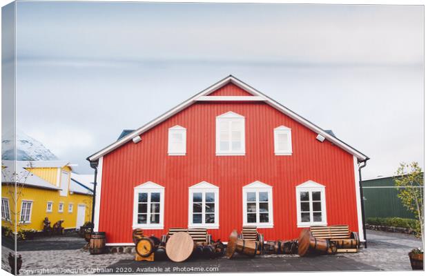 Nice house with red wooden planks in iceland. Canvas Print by Joaquin Corbalan