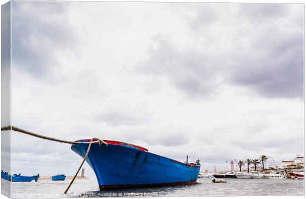 Small boat moored to Bari port, Italy, during a storm at sea. Canvas Print by Joaquin Corbalan