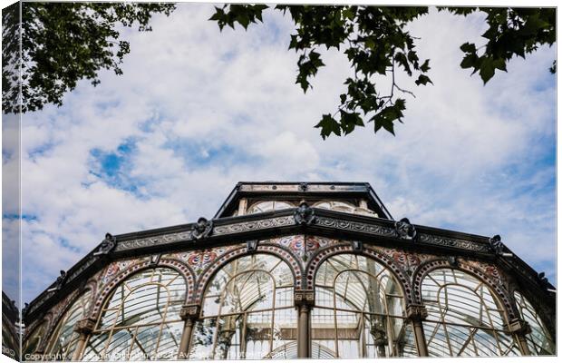 Windows of the glass palace of the Retiro Park in Madrid, with a background of a sky with clouds. Canvas Print by Joaquin Corbalan