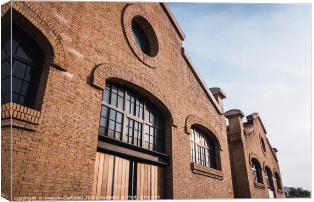 Facade of the old train workshop factories in the Central Park of Valencia. Canvas Print by Joaquin Corbalan