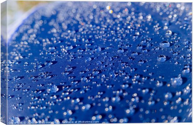Detail of water drops on a plastic fabric colored in the sun. Canvas Print by Joaquin Corbalan