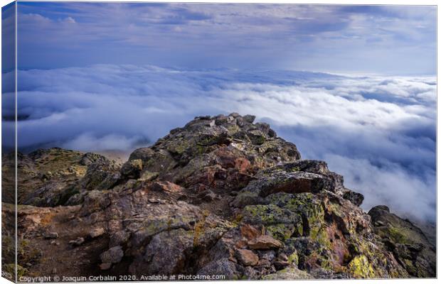 Peñalara Peak, in the Sierra de Guadarrama, seen from the cliff of birds and carnations, a day of clouds. Canvas Print by Joaquin Corbalan