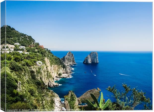 Natural rock arches and cliffs on the coast Sorrento and Capri, Italian islands with crystal clear waters where tourist boats crowd to photograph them in summer. Canvas Print by Joaquin Corbalan