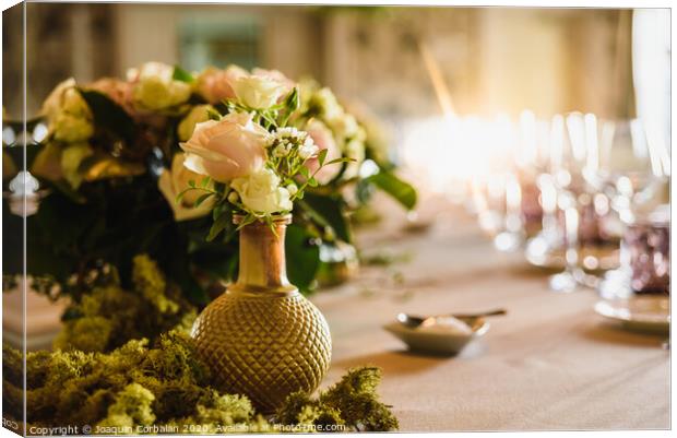 Beautiful vintage vases with roses as centerpieces of decorating tables of a wedding. Canvas Print by Joaquin Corbalan