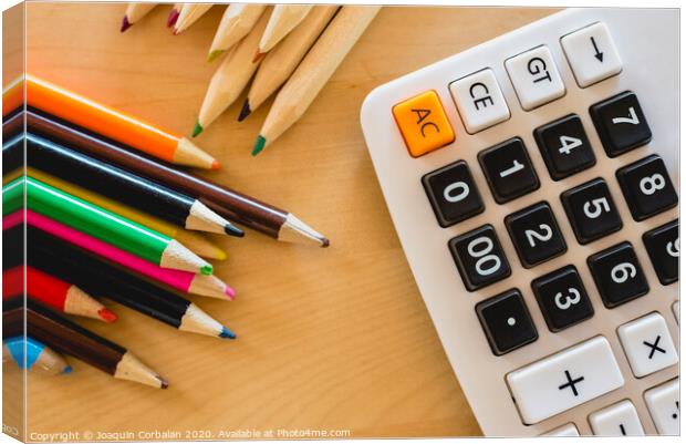 Colored pencils and calculator on a table. Canvas Print by Joaquin Corbalan