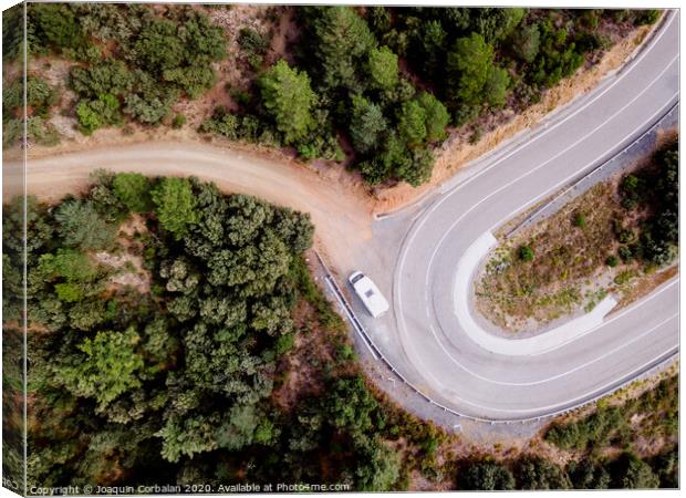 Aerial view of an adventure travel motorhome on a mountain road through a forest Canvas Print by Joaquin Corbalan