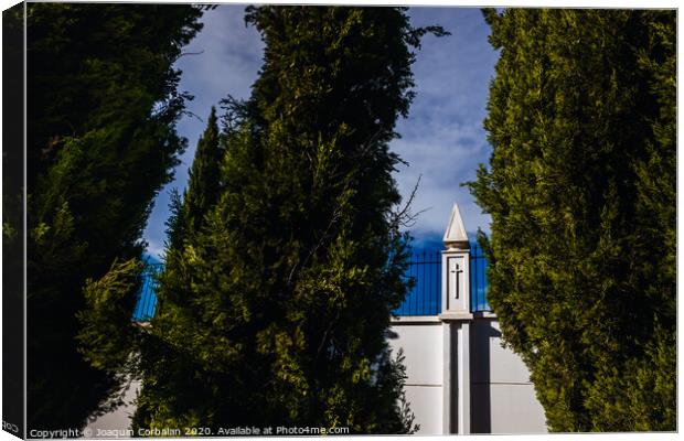 High white concrete walls with metal grating of a cemenery, seen through the cypress trees. Canvas Print by Joaquin Corbalan