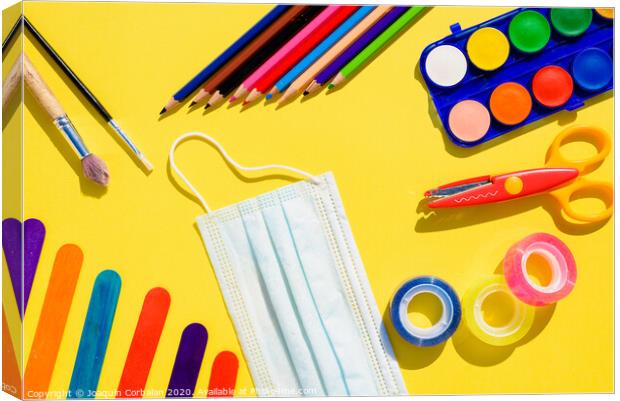 School supplies next to a face mask, flat lay background back to school. Canvas Print by Joaquin Corbalan