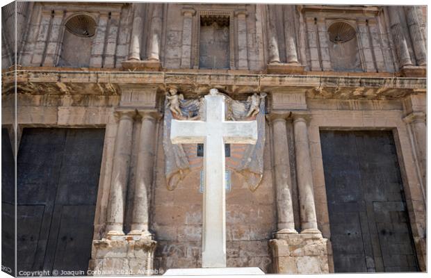Cross carved in white stone, erected in front of a Christian religious church. Canvas Print by Joaquin Corbalan