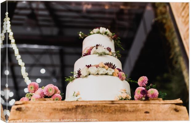 Pretty three-tier wedding cake decorated for a wedding event. Canvas Print by Joaquin Corbalan