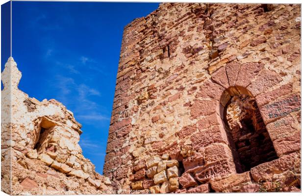 Walls of an old abandoned European castle with blue sky background. Canvas Print by Joaquin Corbalan