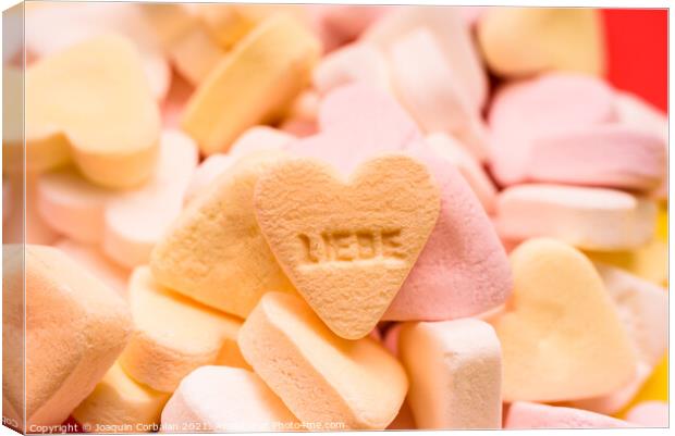 Word love written in German on a candy heart, sweet image for Va Canvas Print by Joaquin Corbalan