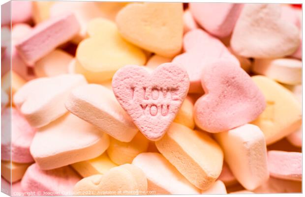 Love word engraved in a sweet romantic heart-shaped candy to giv Canvas Print by Joaquin Corbalan