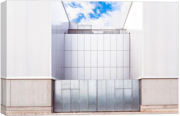 Facade of a door of an industrial warehouse made of gleaming alu Canvas Print by Joaquin Corbalan