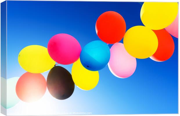 Colorful balloons inflated against the sun, festive and joyful c Canvas Print by Joaquin Corbalan