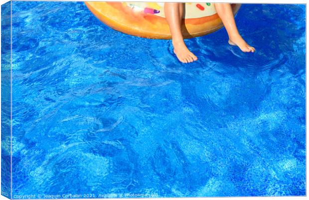 Crystal clear water pool where a child enjoys fun baths during t Canvas Print by Joaquin Corbalan