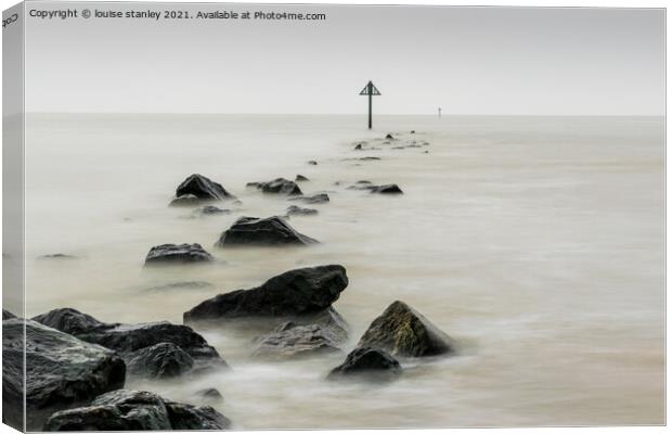 Rising tide over stone groin Canvas Print by louise stanley