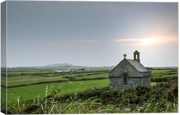 The isolated St Non's Chapel with the sun setting  Canvas Print by David Wall