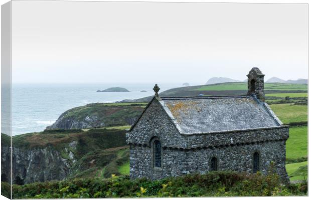 St Non's Chapel on the edge of a wild rugged coast Canvas Print by David Wall